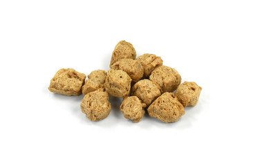 Raw dehydrated soy meat on white background. Pieces of dry soy meat. Textured Soy Protein.