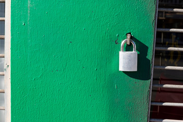 Padlock on Green wall