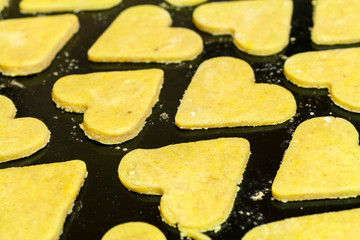 Close up shot of heart shaped cake dough on an owen tray