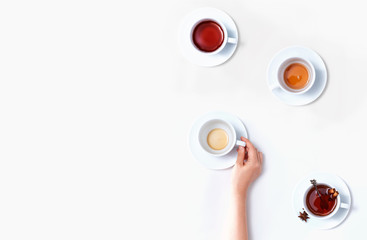Female hand holding a tea cup overhead view - flat lay