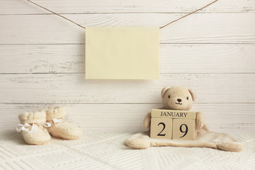 Calendar. January 29th. Day 29th of month. Teddy bear holding wood cube calendar with date of month...