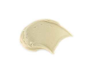 Tahini sauce (sesame seed paste) isolated on white background. Tahini paste smeared on a white surface.