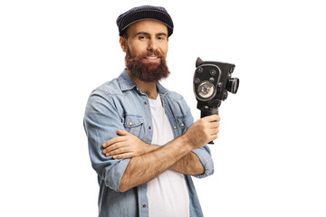Bearded man holding a vintage 8 mm recording camera