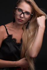 Portrait of a blonde with long hair, in glasses