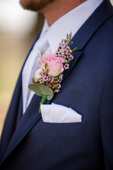 wedding boutonniere on suit of groom