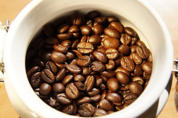 coffee beans in a ceramic container in daylight