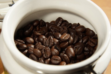 coffee beans in a ceramic container in daylight