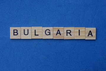 gray word bulgaria from small wooden letters on a blue table