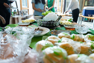 Mixed dessert in high tea break pineapple bread cream and ice black jelly with syrup on decoration leaf on wood table.