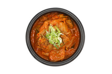 Isolated Kimchi soup in the black stone bowl in studio light on the white background.