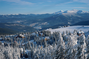 Beautiful white winter wonderland mountain scenery in the Carpathian with traditional houses on a...