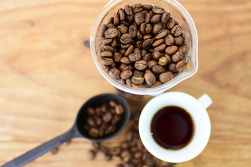 coffee beans, accompanied by cup of hot coffee