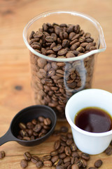 coffee beans, accompanied by cup of hot coffee