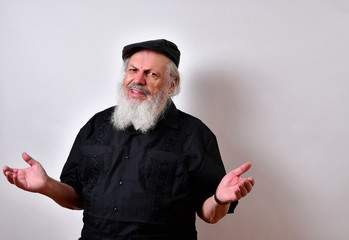 Grumpy old man.Senior man not looking happy .Elderly gentleman with an unhappy expression .. .Mature gentleman with a newsboy cap and black guayabera shirt and long white beard..