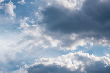 Dark thunder clouds on the blue sky. Abstract background with clouds on blue sky.