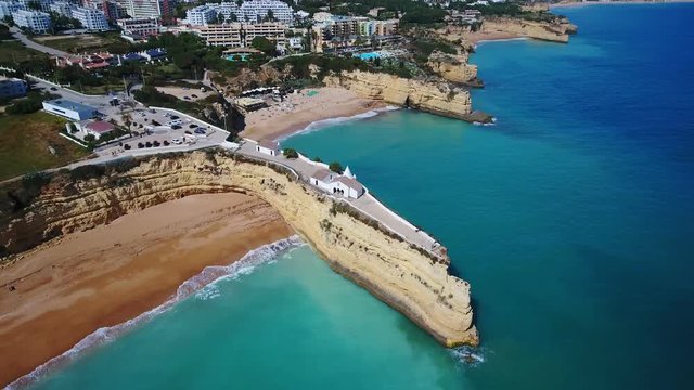 Aerial. Portuguese beach Senhora da Rocha, church on the cape, aerial view. Armacao de Pera Algarve