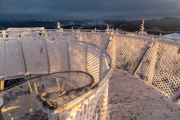 Borowa Gora view point during winter time. Frosty structure, glazed, icy branches and net fence....