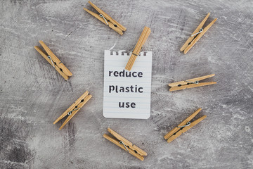 Reduce plastic use message with wooden pegs to hang the washing, sustainable living