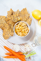hummus and chips with black and white sesame 