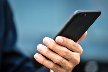 Close up man holding mobile smart phone