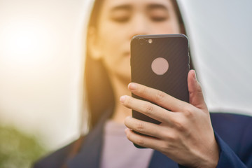 Business woman use smart phone at a car