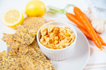hummus and chips with black and white sesame 