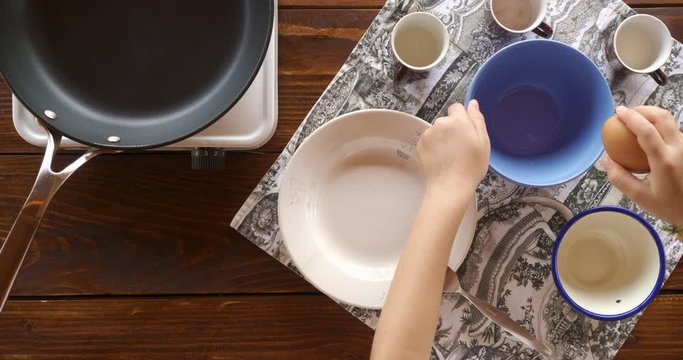 Top view food. Cooking With Mother. Beautiful Little Girl Learns How To Make Fried Egg.