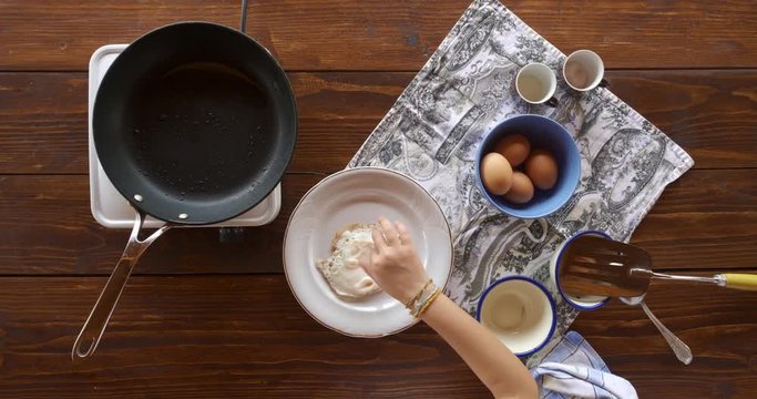 Top view food. Cooking With Mother. Beautiful Little Girl Learns How To Make Fried Egg.