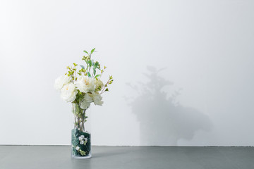 Bouquet in vase on white background. Modern lifestyle concept. - obrazy, fototapety, plakaty