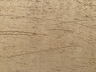 Brown gold decorative plaster on uneven walls during apartment renovation. Repair and decoration of premises. Background texture pattern copy space