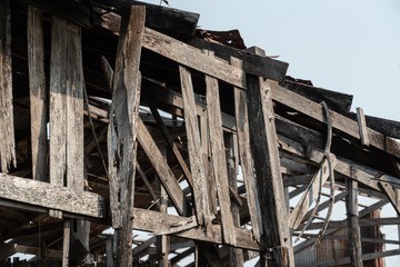 Ruins of an abandoned wooden house, rusty galvanized sheet roof