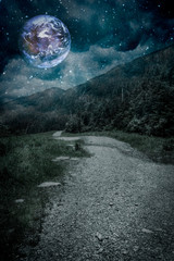 Mountain path with planet in night sky