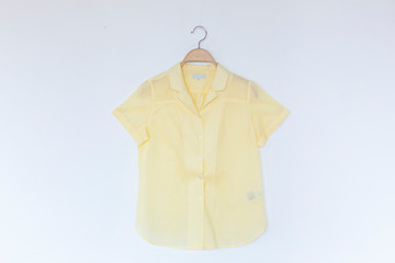 Woman blouse with yellow blouse cotton on white background.