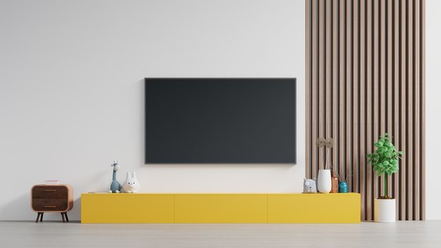 TV on Yellow cabinet or place object in modern living room with lamp,table,flower and plant on white wall background.