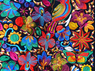  Close up of сolorful embroidered decorative textile and pillows from Otavalo city at the artisans market