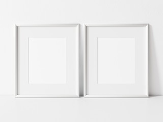 Two vertical white frame mockup. White frame on white table mock up. 3d illustrations.