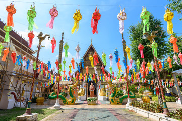 Beautiful view of Wat Phra Singh temple with traditional paper lanterns hanging on the rows during...