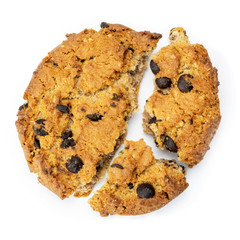 Broken cookie with chocolate chips in close - up isolated on white background. Top view, flat lay.