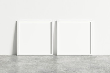 Two square white frame mock up on concrete floor. Blank two white frame. 3d illustrations.