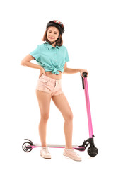 Teenage girl with kick scooter on white background © Pixel-Shot