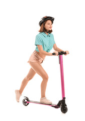 Teenage girl riding kick scooter on white background © Pixel-Shot