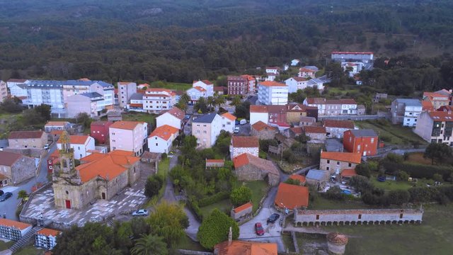 Panning up landscape of town Carnota and iconic horreo in Galicia, Spain
