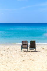 Beach chair on white sand over blue sea and clear blue sky, summer outdoor day light, relaxing by the sea, holiday and vacation destination