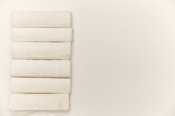 Bandages in rolls on a white background, top view. The concept of first aid for injuries, sprains, dislocations and fractures.
