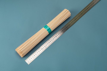 Bamboo sticks made of bamboo are often used as barbecue tools on a green background