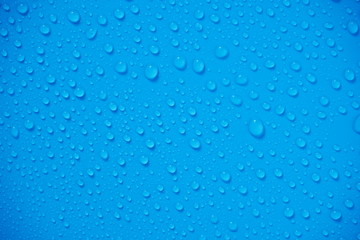 Plakat Water Drops On Blue Background.