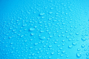 Naklejka na ściany i meble Water Drops On Blue Background.