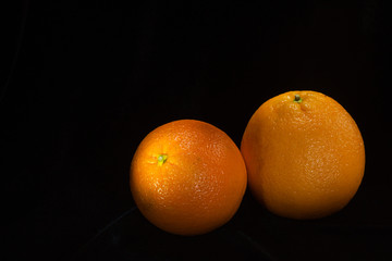 Two Gorgeous Oranges - Isolated on Black Velvet