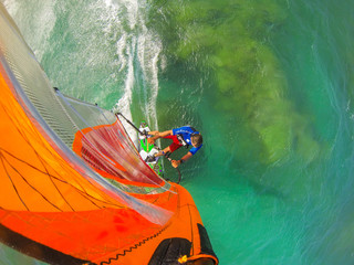 Funny windsurfing on the crystal clear waters and reef