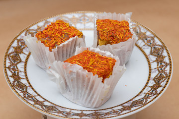 Three slices of fruit saffron lokum on a saucer, a traditional o
